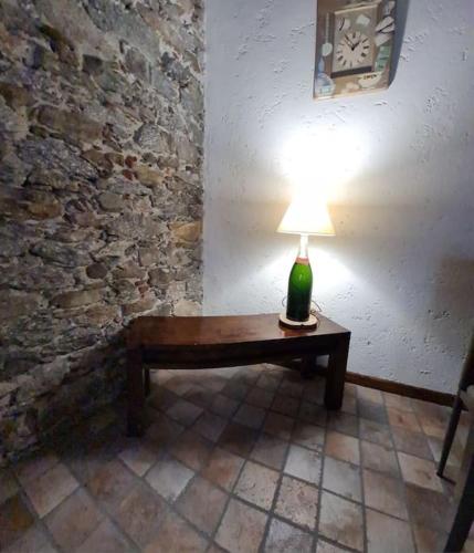 a lamp sitting on a wooden table in a room at Fun it House in Mezzenile