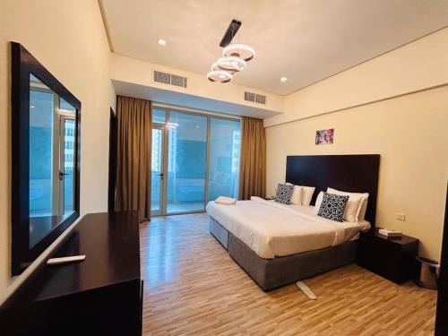 a hotel room with a bed and a television at Aspire Tower -Chic City Escape Juffair in Manama