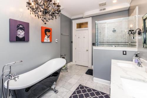 a bathroom with a bath tub and a sink and a tub at Luxury Brownstone - Walk to ALL - Washington Park in Cincinnati