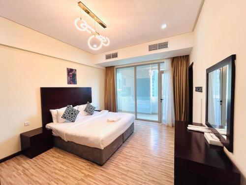 a hotel room with a bed and a tv at Aspire Tower-The Tranquil Haven in Manama