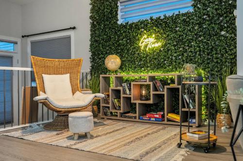 a patio with a chair and a green wall at 3 Bedroom Sage House with AC, Driveway Parking, King Bed & More in Calgary
