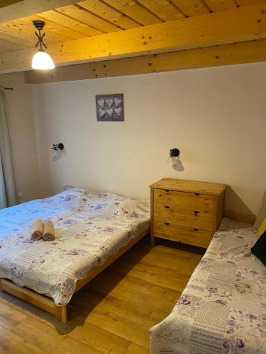 a bedroom with a bed and a dresser with shoes on it at Chata Bystrá in Mýto pod Ďumbierom