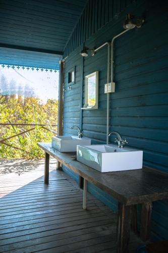 a bathroom with two sinks on a wooden deck at Hidden Island Hostel in Tigre
