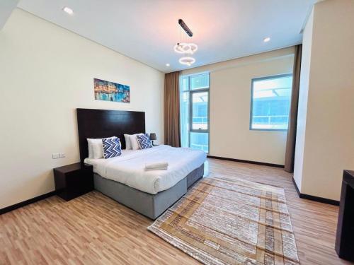 a bedroom with a bed and a television in it at Aspire Tower # Serenity Suite Juffair in Manama