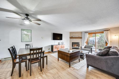 a living room with a table and a couch at Lincoln Apartment with Balcony 2 Mi to Loon Mtn! in Lincoln
