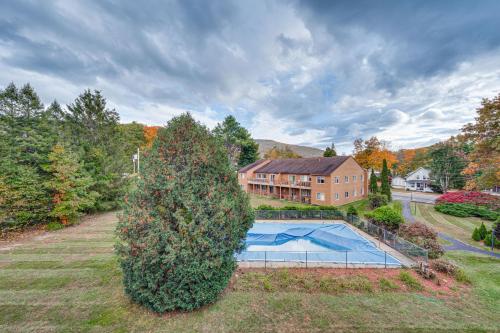 an aerial view of a house with a swimming pool at Lincoln Apartment with Balcony 2 Mi to Loon Mtn! in Lincoln