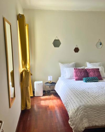 a bedroom with a large bed and a table at Vagabond Mermaid Guesthouse in Ponta Delgada