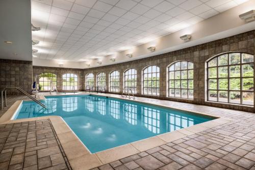 a swimming pool with windows in a building at Holiday Inn Express Hotel & Suites Hagerstown by IHG in Hagerstown