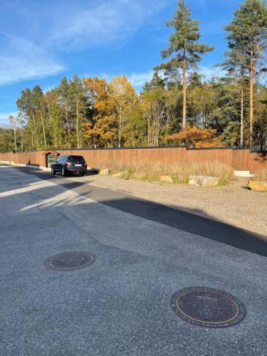 a car parked on the side of a road at Lys rent og trivelig hybelleilighet in Kristiansand