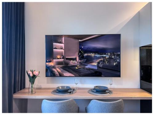a living room with a tv hanging on the wall at Balticus Playa Margarita in Międzyzdroje