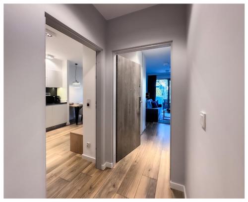 a hallway with a door leading to a living room at Balticus Playa Margarita in Międzyzdroje