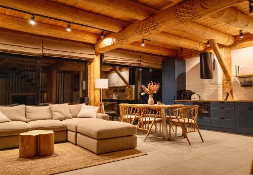 a living room with a couch and a table at Sęk w Ciszy - Free Sauna & Balia in Szczyrk