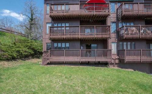 an apartment building with balconies and a field of grass at Lake View Condo in Basye