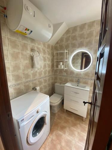 a bathroom with a washing machine and a sink at Beach Appartement Denia in Denia