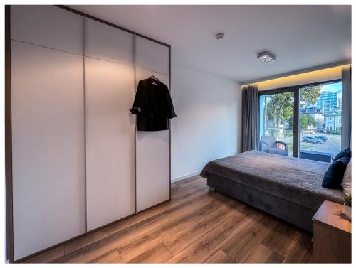 a bedroom with a bed and a large sliding door at Balticus Playa Margarita in Międzyzdroje