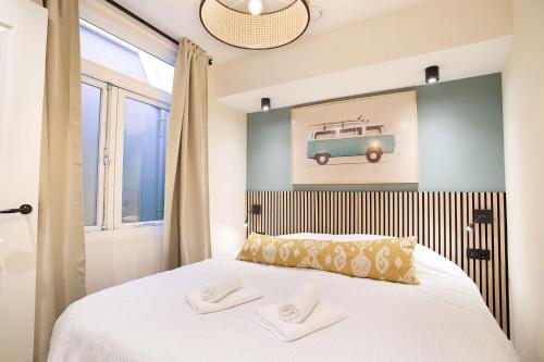 a bedroom with a bed with a picture of a car on the wall at Curated apartment near Scheveningen beach in Scheveningen