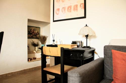 a living room with a table and a couch at Etna Garden Francesca in Presa