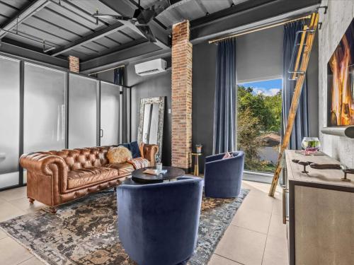 a living room with a couch and a table at Luxury Loft - Downtown Tampa, Ybor, Armature in Tampa