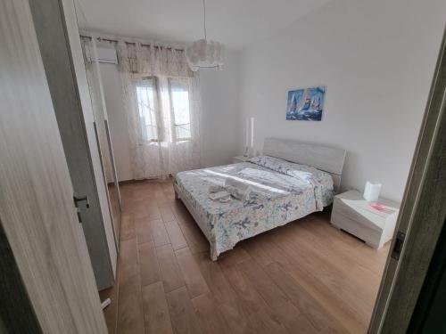 a small bedroom with a bed and a window at Pietra Marina in Capaci