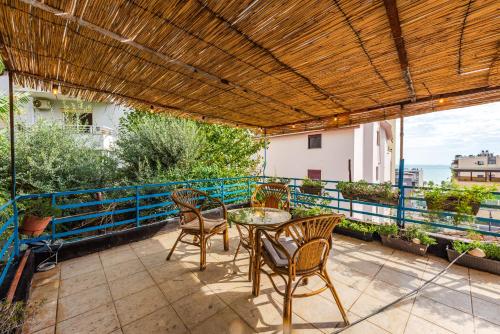 a patio with chairs and a table on a balcony at Central Vila 5 in Durrës