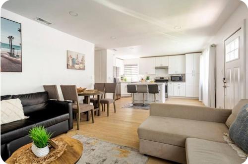 a living room with a couch and a dining room at The Heart Of LA House in Los Angeles