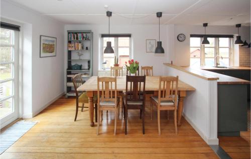 a kitchen and dining room with a table and chairs at Cozy Home In Samsø With Wifi in Kolby Kås