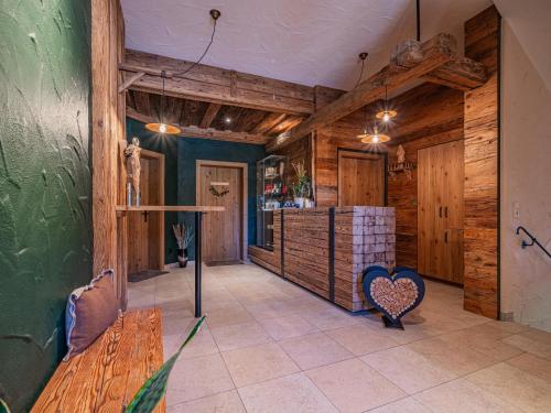 a room with wooden walls and a table and a bench at Premium Apartment Wildkogel in Hollersbach im Pinzgau