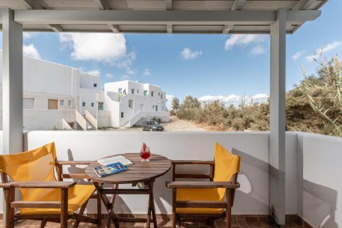 a table and chairs on the balcony of a house at Golden Sand in Plaka