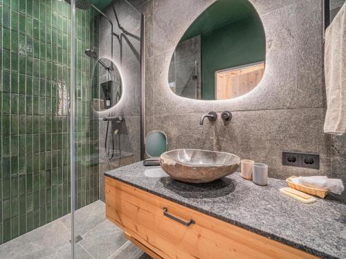 a bathroom with a sink and a glass shower at Premium Apartment Sunnseit in Hollersbach im Pinzgau