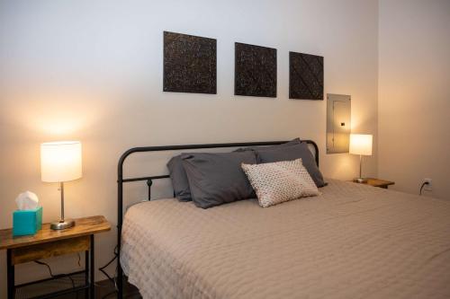a bedroom with a bed with two tables and two lamps at City Hall Clerk's Office in Rochester