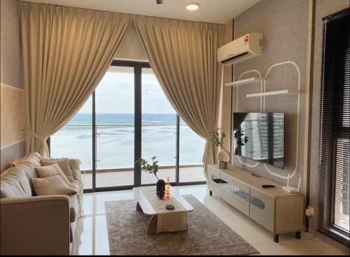 a living room with a couch and a large window at Muji Full Seaview Royal Strand with 2CarParks FOC Netflix Access and Youtube Premium 3Beds 3Bath for 6-12pax by Minshuku in Johor Bahru