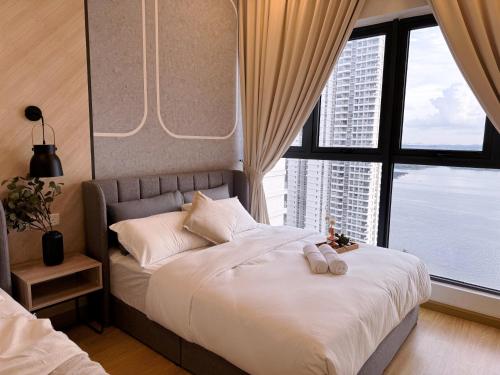 a bedroom with a white bed with a large window at Muji Full Seaview Royal Strand with 2CarParks FOC Netflix Access and Youtube Premium 3Beds 3Bath for 6-12pax by Minshuku in Johor Bahru