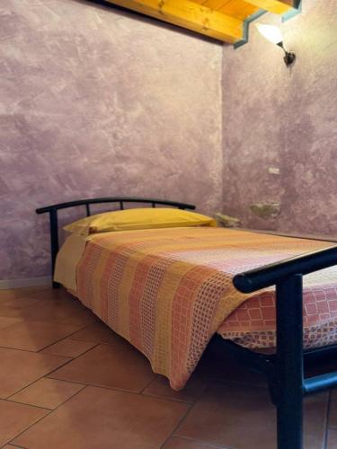 a bed sitting in a room with at B&B Al Vec Licinsi' in Moniga