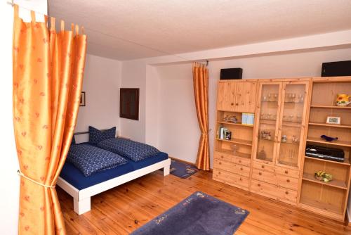 a bedroom with a bed and a wooden floor at Ferienwohnung am Hafen in Lübbenau