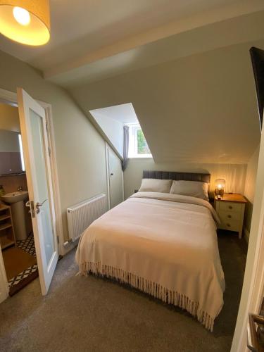 a bedroom with a bed in a room with a window at Fern House in Cork
