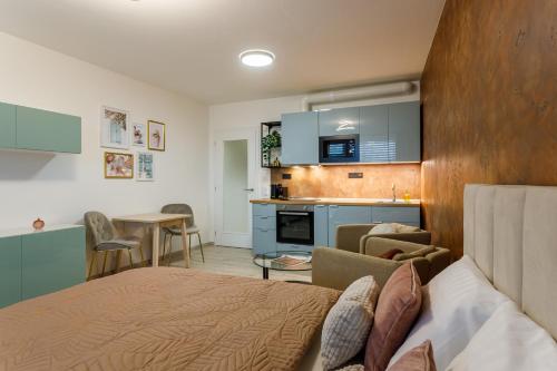 a bedroom with a bed and a kitchen in a room at Terrace View Apartment - Golden Apartments Rezidence Nová Karolina in Moravská Ostrava
