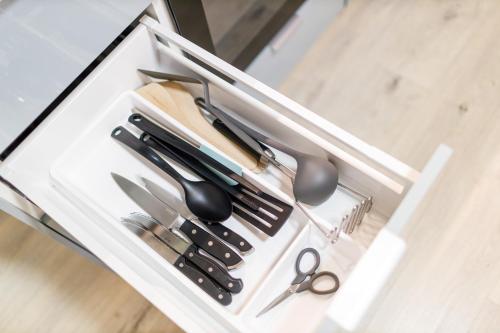 a drawer filled with scissors and other kitchen utensils at Terrace View Apartment - Golden Apartments Rezidence Nová Karolina in Moravská Ostrava