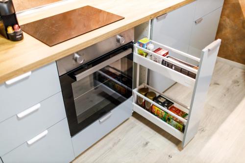 a kitchen with an open oven with food inside at Terrace View Apartment - Golden Apartments Rezidence Nová Karolina in Moravská Ostrava