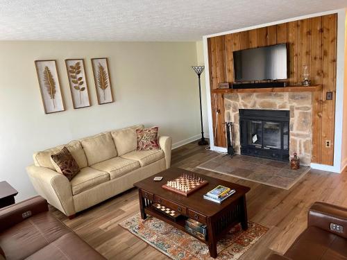 a living room with a couch and a fireplace at Lake View Condo in Basye