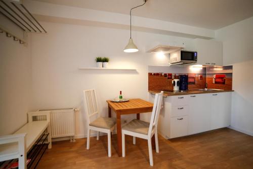a kitchen with a table and chairs in a room at Captain Pahlen Ferienanlage in Zingst