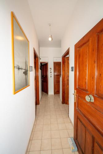 a hallway with a door and a picture on the wall at Aegina Town Cozy Escape in Aegina Town