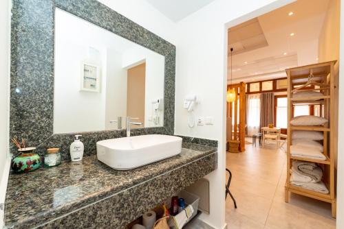 a bathroom with a sink and a mirror at Aegina Town Cozy Escape in Aegina Town