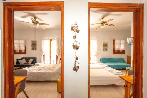 a room with a mirror and a bedroom with a bed at Aegina Town Cozy Escape in Aegina Town