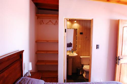 a bedroom with a bathroom with a sink and a toilet at La Casa del Pueblo Hostal in San Pedro de Atacama