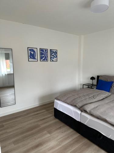 a bedroom with a bed and three pictures on the wall at Handelshaus in Meppen