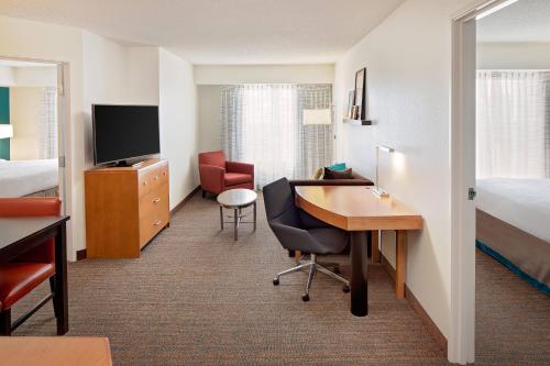a hotel room with a desk and a bed at Residence Inn Harrisburg Hershey in Harrisburg