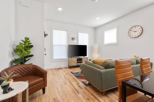 a living room with a couch and a tv at Dog-Friendly Apt with Fenced Yard in Richmond, VA! in Richmond