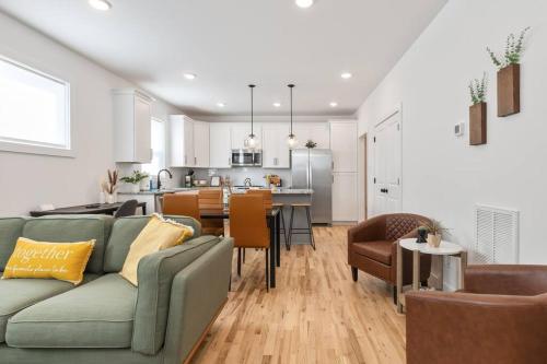 a living room with a green couch and a kitchen at Dog-Friendly Apt with Fenced Yard in Richmond, VA! in Richmond