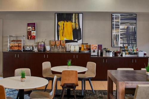 a restaurant with two tables and chairs and a counter at Residence Inn Atlanta Airport North/Virginia Avenue in Atlanta