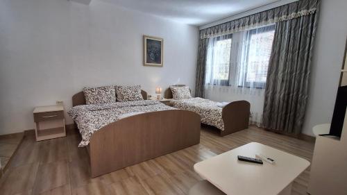 a bedroom with a couch and a bed and a table at Apartments Tomic in Ohrid